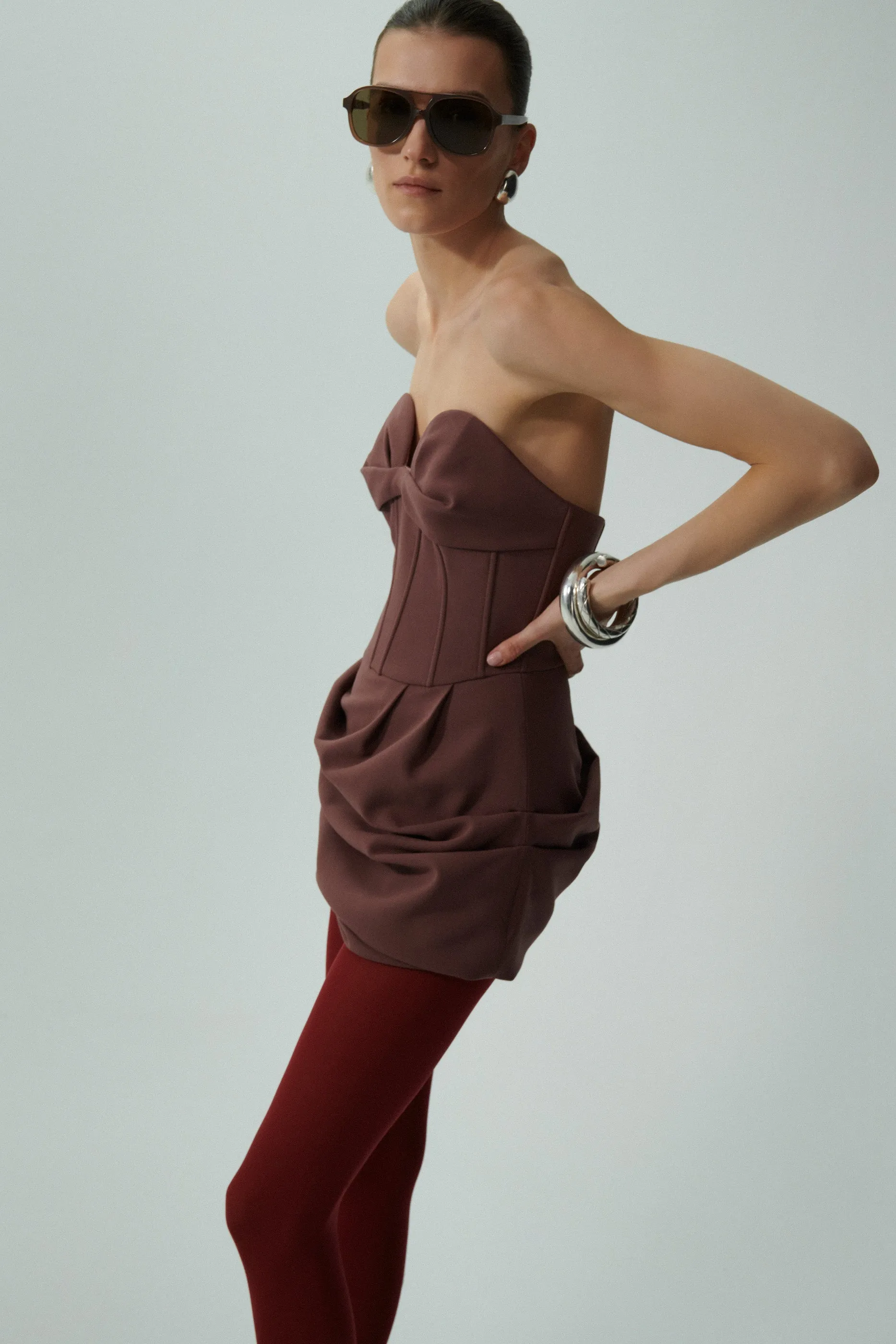 Draped strapless babydoll dress in burgundy